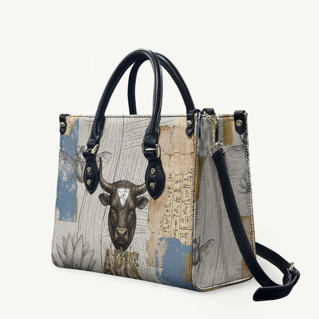 Apis Ancient Egyptian Leather Bag with Beige-Gray Hieroglyphic, Ornate Bull Head, and Gold-Blue Typography - African Pride
