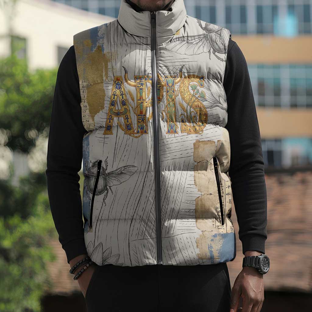 Apis Ancient Egyptian Sleeveless Puffer Jacket with Beige-Gray Hieroglyphic, Ornate Bull Head, and Gold-Blue Typography - African Pride